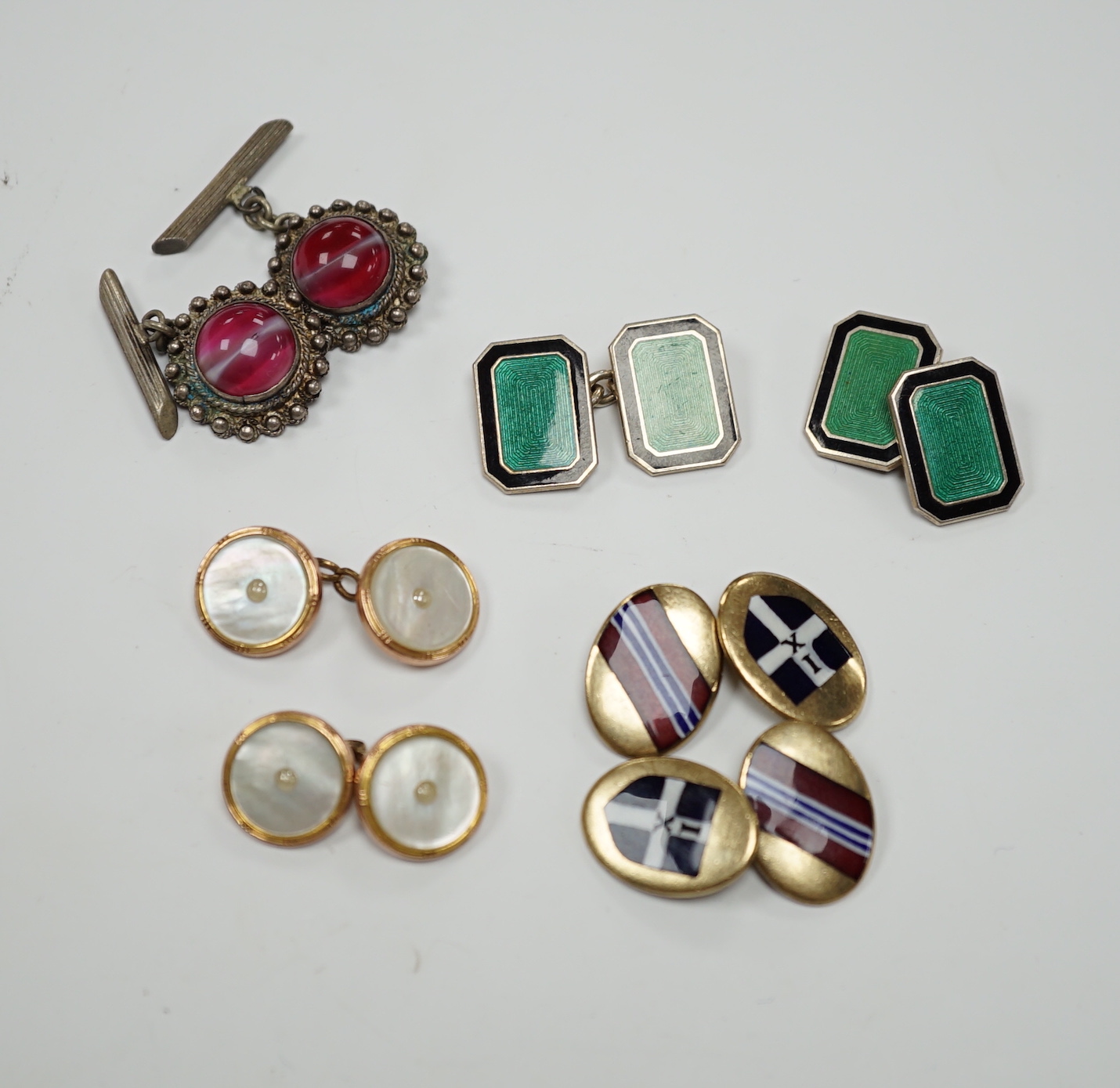 Four assorted pairs of cufflinks including silver and two coloured enamel.